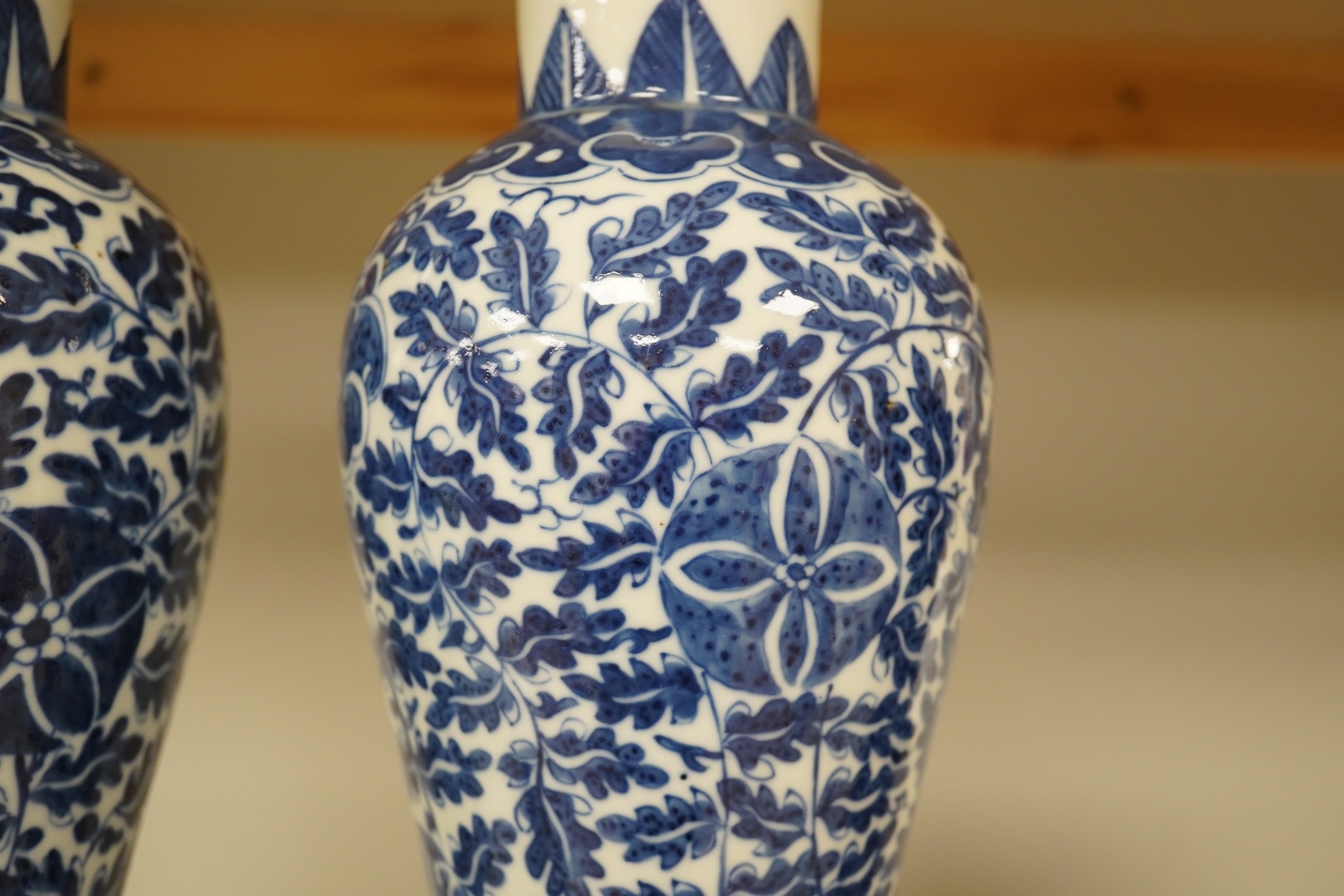 A pair of Chinese blue and white lotus decorated baluster vases and covers, late 19th century